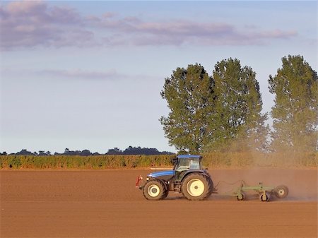 simsearch:400-05706113,k - a tractor rolling a field on a warm summer evening Stock Photo - Budget Royalty-Free & Subscription, Code: 400-04637028