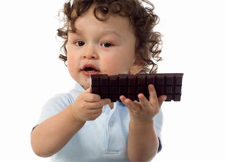 simsearch:673-02138312,k - Child eats chocolate, isolated on a white background. Stockbilder - Microstock & Abonnement, Bildnummer: 400-04637178