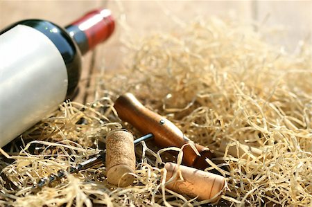 simsearch:400-05286682,k - Bottle of red wine with corkscrew and packing straw Stock Photo - Budget Royalty-Free & Subscription, Code: 400-04637290