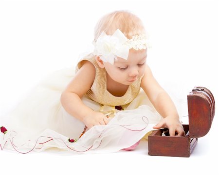A winsome toddler searching for treasure in a trunk Stock Photo - Budget Royalty-Free & Subscription, Code: 400-04637378