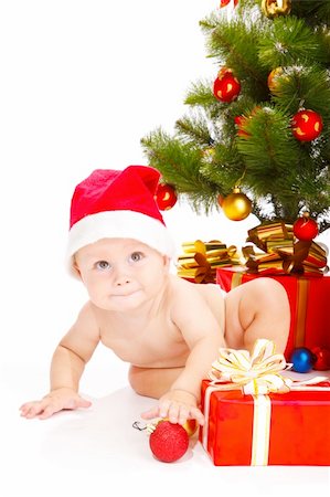 simsearch:400-06557484,k - Baby in a red hat sitting under the Christmas tree Stockbilder - Microstock & Abonnement, Bildnummer: 400-04637380