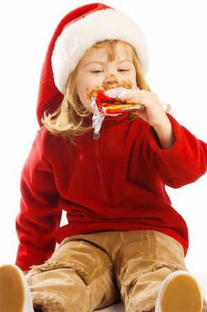 Sweet preschool girl biting a chocolate bar Stock Photo - Budget Royalty-Free & Subscription, Code: 400-04637406