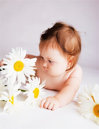 Baby with camomiles, on a gray background Stock Photo - Budget Royalty-Free & Subscription, Code: 400-04637418