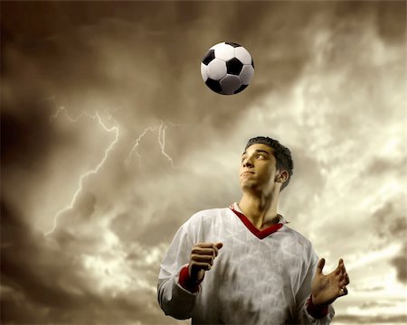 football flying - soccer or football  player against a stormy sky Stock Photo - Budget Royalty-Free & Subscription, Code: 400-04638364