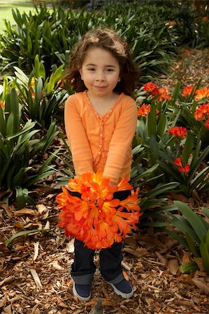 Little girl with a bunch of clivia miniata (bush lilies) from the garden Stock Photo - Budget Royalty-Free & Subscription, Code: 400-04638631