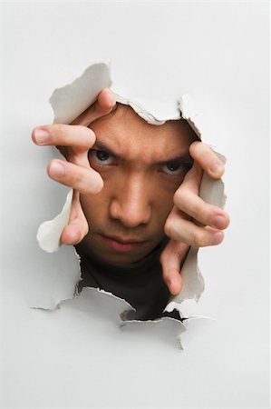 peeping through - Man with scary look from cracked wall - one of the breakthrough series Stock Photo - Budget Royalty-Free & Subscription, Code: 400-04639550