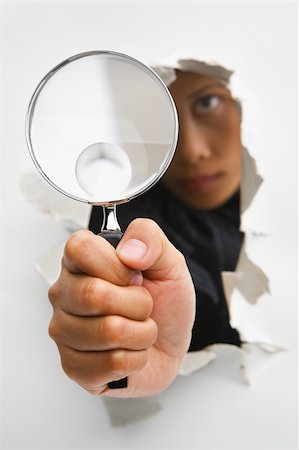 Detective holding magnifying glass from cracked wall means breakthrough in investigation - one of the breakthrough series. PS : focus on the magnifying glass Stock Photo - Budget Royalty-Free & Subscription, Code: 400-04639565