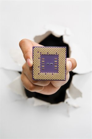 simsearch:400-04639602,k - Hand holding new processor from cracked wall means breakthrough in technology - one of the breakthrough series Stock Photo - Budget Royalty-Free & Subscription, Code: 400-04639566