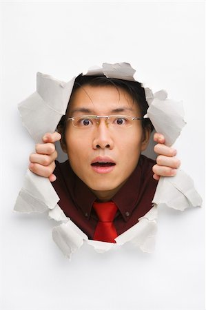 Man gazing surprisingly from hole in wall with copy space in horizontal position Stock Photo - Budget Royalty-Free & Subscription, Code: 400-04639574