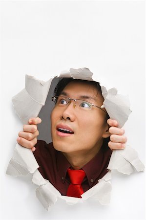 Man looking up happily from hole in wall Stock Photo - Budget Royalty-Free & Subscription, Code: 400-04639575