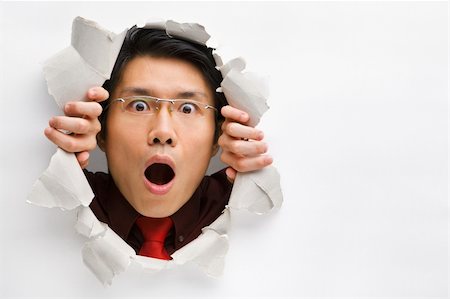 Man gazing surprisingly from hole in wall with copy space in horizontal position Stock Photo - Budget Royalty-Free & Subscription, Code: 400-04639589