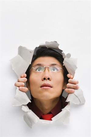 Man looking up from hole in wall Foto de stock - Super Valor sin royalties y Suscripción, Código: 400-04639581