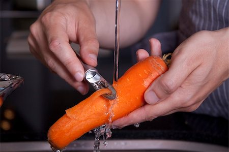Peeling a carrot in a modern kitchen Stock Photo - Budget Royalty-Free & Subscription, Code: 400-04630141