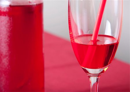 simsearch:400-06911038,k - Red cocktail in a glass with a straw and a bottle Stock Photo - Budget Royalty-Free & Subscription, Code: 400-04630407