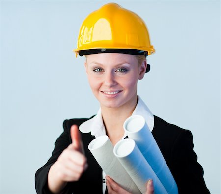 Young female constrcution worker with blueprints Stock Photo - Budget Royalty-Free & Subscription, Code: 400-04630902