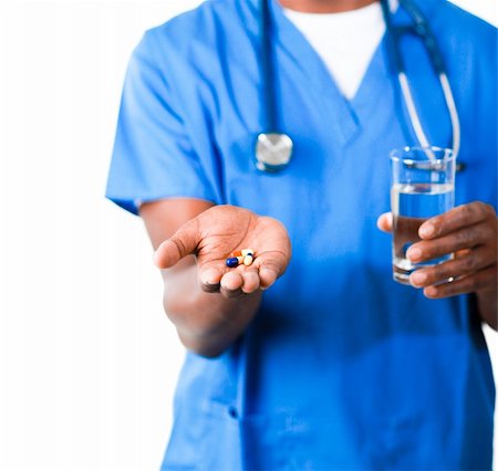 simsearch:400-04130714,k - Close-up of an friendly Afro-American doctor in scrubs with pills and glass of water Photographie de stock - Aubaine LD & Abonnement, Code: 400-04630980