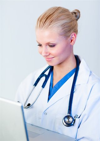 doctor business computer - Young attractive Female doctor working on a laptop Stock Photo - Budget Royalty-Free & Subscription, Code: 400-04631022