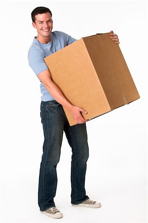 A man is holding a moving box and smiling at the camera.  Vertically framed shot. Stock Photo - Budget Royalty-Free & Subscription, Code: 400-04631096