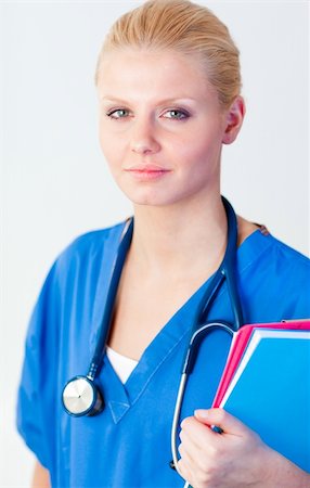 Young attractive female doctor holding a folder Stock Photo - Budget Royalty-Free & Subscription, Code: 400-04631144
