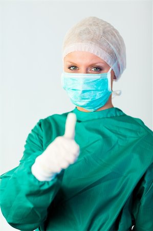 doctor with cap and mask - Young Female surgeon with Person in Focus Stock Photo - Budget Royalty-Free & Subscription, Code: 400-04631151