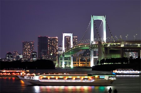 simsearch:400-04775919,k - very famous Tokyo landmark, Tokyo Rainbow bridge over bay waters with scenic night illumination and traditional japanese boats Photographie de stock - Aubaine LD & Abonnement, Code: 400-04631391