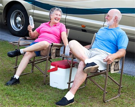 senior couple rv - Senior campers sitting in folding chairs outside their motor home. Stock Photo - Budget Royalty-Free & Subscription, Code: 400-04631516