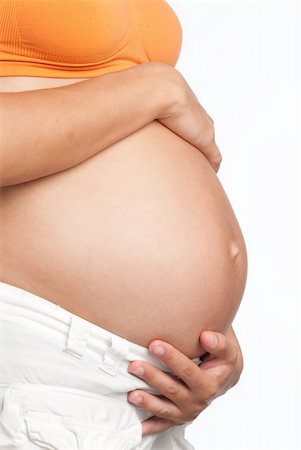 simsearch:400-08376526,k - Pregnant Woman Belly with a White background Photographie de stock - Aubaine LD & Abonnement, Code: 400-04631590