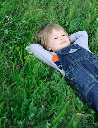 simsearch:400-08415463,k - The boy on a green grass. The weakened condition of the small child Stock Photo - Budget Royalty-Free & Subscription, Code: 400-04631729