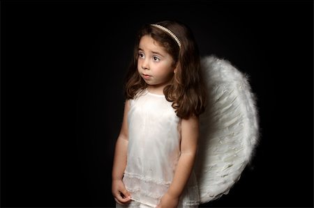 Angelic little girl looking sideways with space for copy. Stock Photo - Budget Royalty-Free & Subscription, Code: 400-04632005