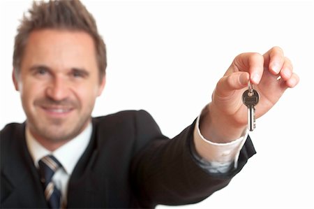 Friendly Businessman wants to give over the house key Stock Photo - Budget Royalty-Free & Subscription, Code: 400-04632724