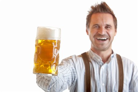 Bavarian man dressed with leather trousers is holding an Oktoberfest Beer Stein into camera. Isolated on white background. Stock Photo - Budget Royalty-Free & Subscription, Code: 400-04632722