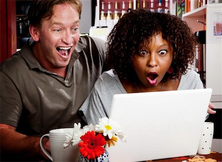 porão - Caucasian man and African American woman in coffee house with laptop computer Stock Photo - Budget Royalty-Free & Subscription, Code: 400-04633183