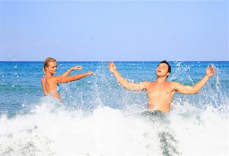 Portrait of joyful couple of people having fun in the sea and laughing Stockbilder - Microstock & Abonnement, Bildnummer: 400-04633280