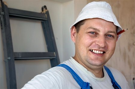 picture of old man construction worker - mature man worker wearing a uniform with a pencil behind his ear Stock Photo - Budget Royalty-Free & Subscription, Code: 400-04633498