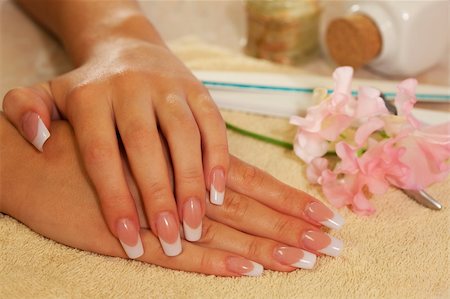 Hands of young woman with french manicure on the towel Foto de stock - Royalty-Free Super Valor e Assinatura, Número: 400-04633507