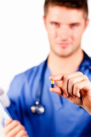 simsearch:400-04048509,k - Young male doctor holding a pill and looking at the camera Stockbilder - Microstock & Abonnement, Bildnummer: 400-04633623