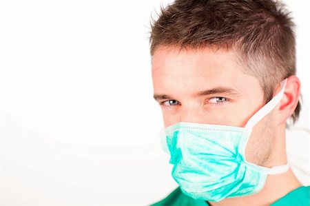 doctor patient standing white background - Attractive young surgeon with mask looking at the camera Stock Photo - Budget Royalty-Free & Subscription, Code: 400-04633830