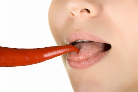 simsearch:400-04575822,k - girl close up licking chili pepper isolated on white Photographie de stock - Aubaine LD & Abonnement, Code: 400-04644672