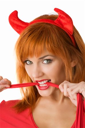 extreme performers - close up of a red haired girl with horns like a devil biting a red tail Stock Photo - Budget Royalty-Free & Subscription, Code: 400-04645837