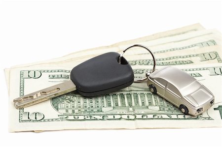 Car key and dollar bills on white background with shallow depth of field Stock Photo - Budget Royalty-Free & Subscription, Code: 400-04646035