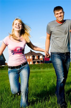 Happy couple running outdoors outside their home Photographie de stock - Aubaine LD & Abonnement, Code: 400-04646085