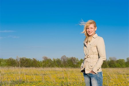 simsearch:400-04982004,k - The young smiling girl standing on field Stock Photo - Budget Royalty-Free & Subscription, Code: 400-04646091