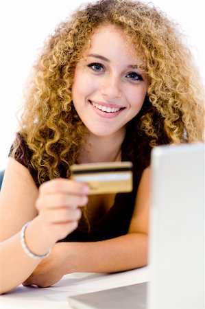 eastwestimaging (artist) - A young pretty woman with laptop computer and credit card on white background Fotografie stock - Microstock e Abbonamento, Codice: 400-04646211