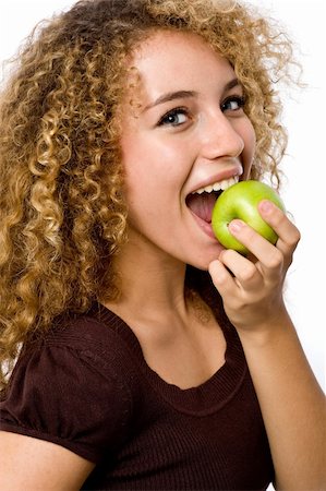 eastwestimaging (artist) - A pretty young woman holding an apple she's about to eat Foto de stock - Super Valor sin royalties y Suscripción, Código: 400-04646241