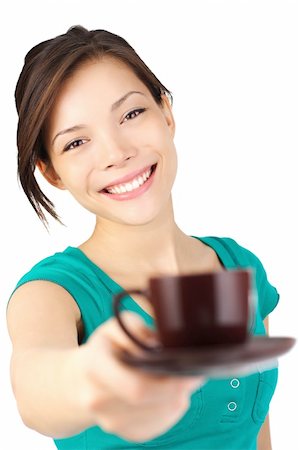 Coffee. Beautiful young woman with big smile serving an espresso. Cup is sharp, model out of focus. Isolated on white. Stock Photo - Budget Royalty-Free & Subscription, Code: 400-04646568