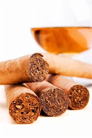 Stock image of Cigars and Cognac over light background, focus on center cigars. Photographie de stock - Aubaine LD & Abonnement, Code: 400-04646585