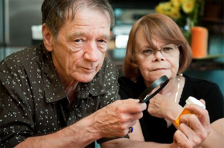 Senior couple closely examining instructions on prescription medications Stock Photo - Budget Royalty-Free & Subscription, Code: 400-04646589