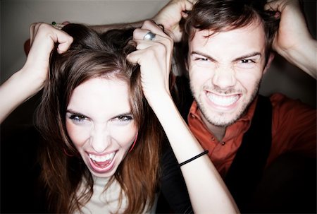 person screaming pulling hair - Crazy young couple pulling on their own hair Stock Photo - Budget Royalty-Free & Subscription, Code: 400-04646608