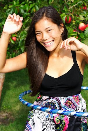 Hula hoop. Very beautiful young woman doing hula hoop outdoors in late summer. Stock Photo - Budget Royalty-Free & Subscription, Code: 400-04647706