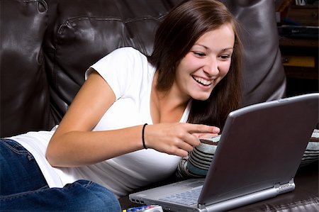 Smiling Teenager Looking at the Laptop at home Photographie de stock - Aubaine LD & Abonnement, Code: 400-04647922